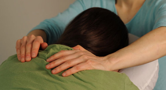 Client receives a relaxing seated chair massage